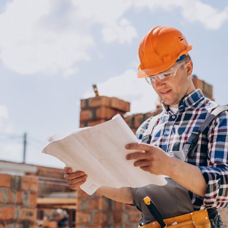 Young craftsman building a house